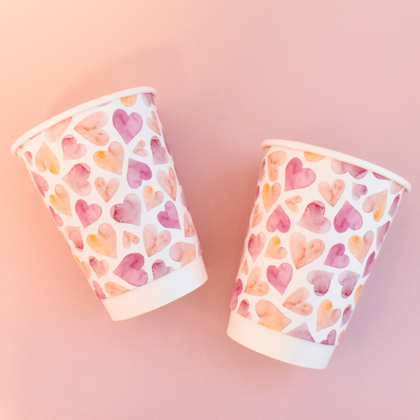 2 paper cups heart design on pink background