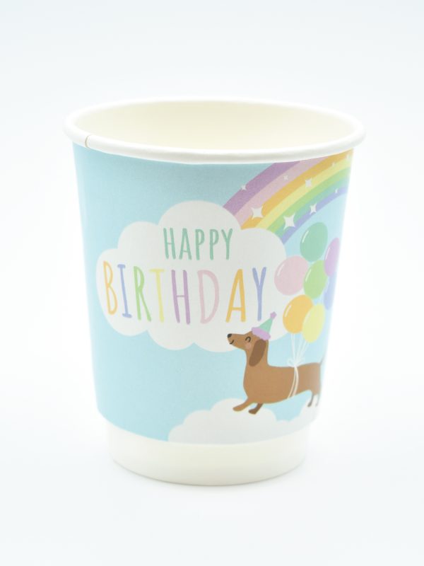 Paper cup featuring a pastel sausage dog design with clouds, rainbows, and sparkles – fun, colourful, and recyclable, ideal for parties or cafés.